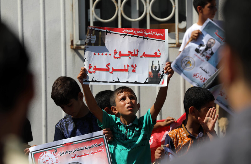 Young boy holds up a banner