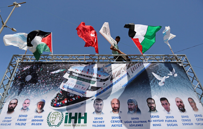 Large banner with flags, photos and names of victims