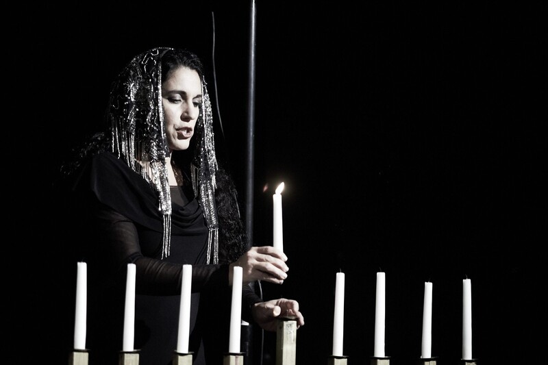 Woman lighting menorah candles 