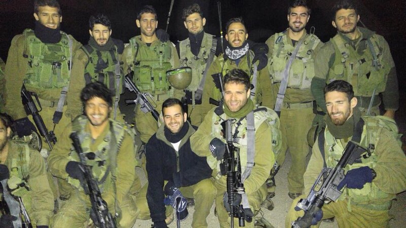 Men stand with rifles 
