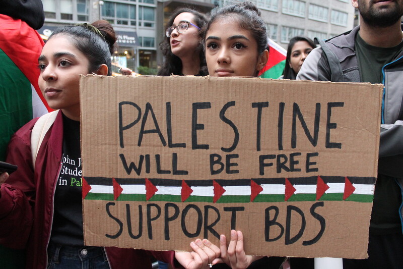 A woman holds a sign at a protest