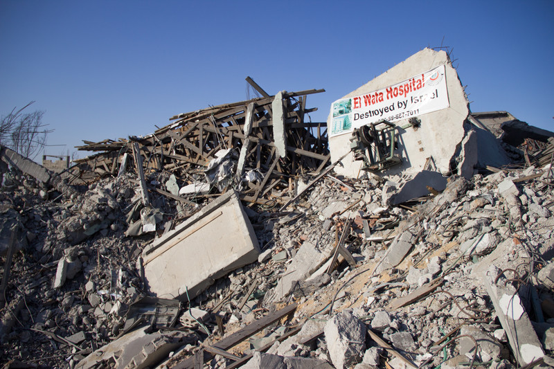 Banner on rubble says Al Wafa Hospital Destroyed by Israel