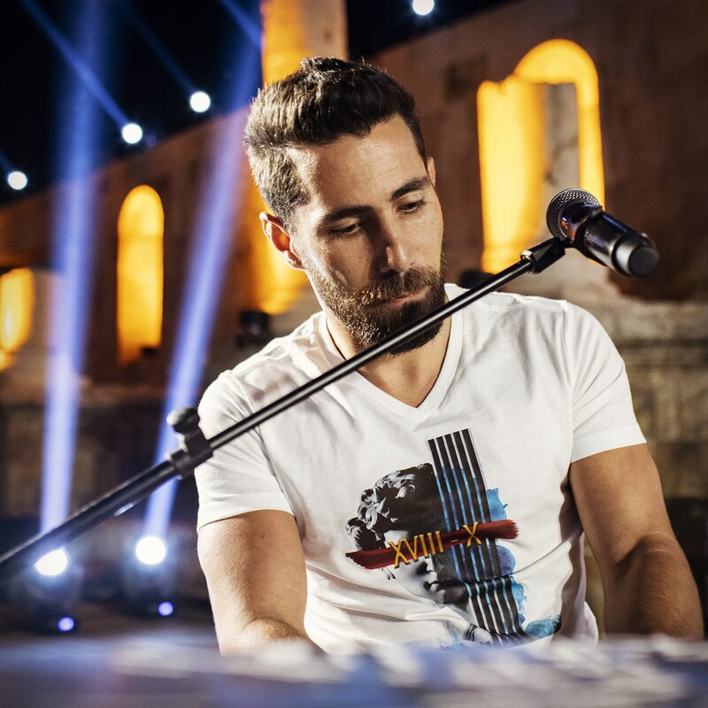 Man sits behind microphone
