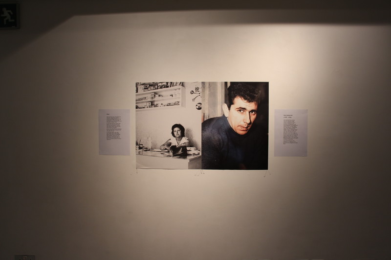 Photos of woman and man hang side by side on wall