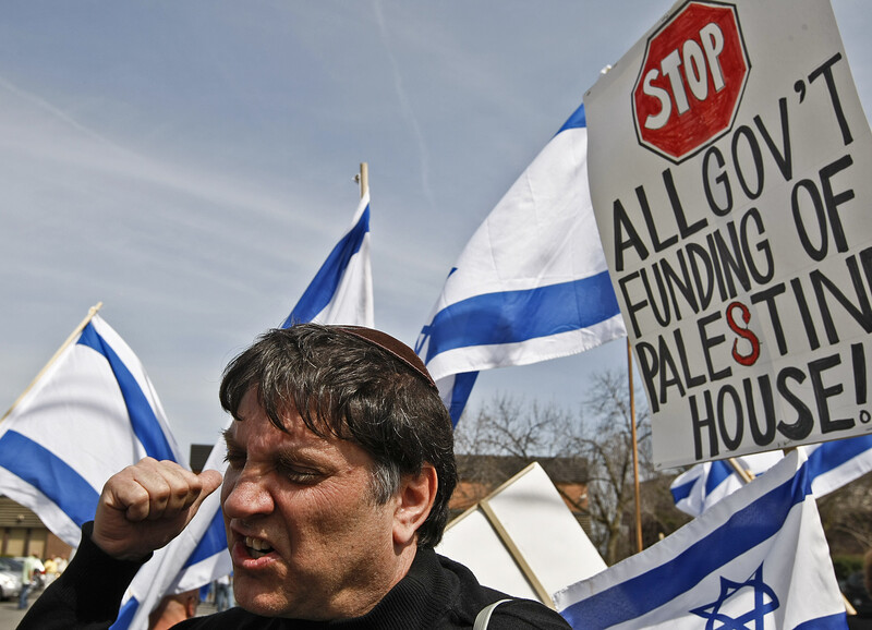 Close up of a man's face and Israeli flags