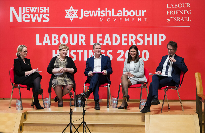 Three women and two men sit on a platform