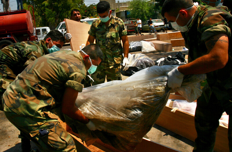 Men wearing masks carry large translucent bag