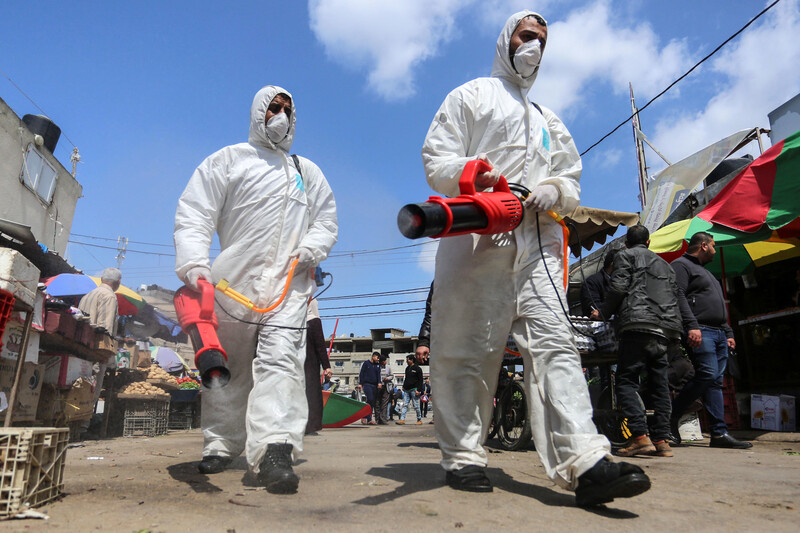 Medical workers disinfecting market 