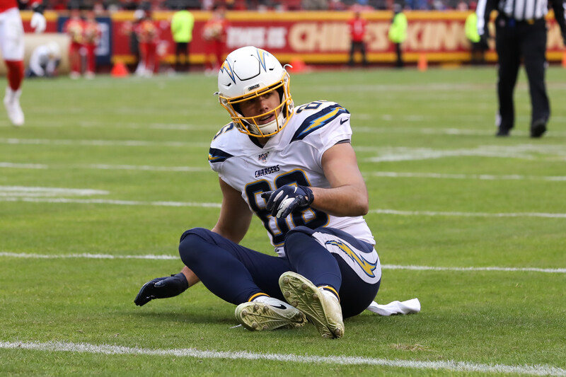 Football player sits on field