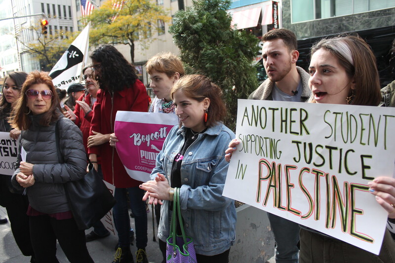 People standing, holding signs