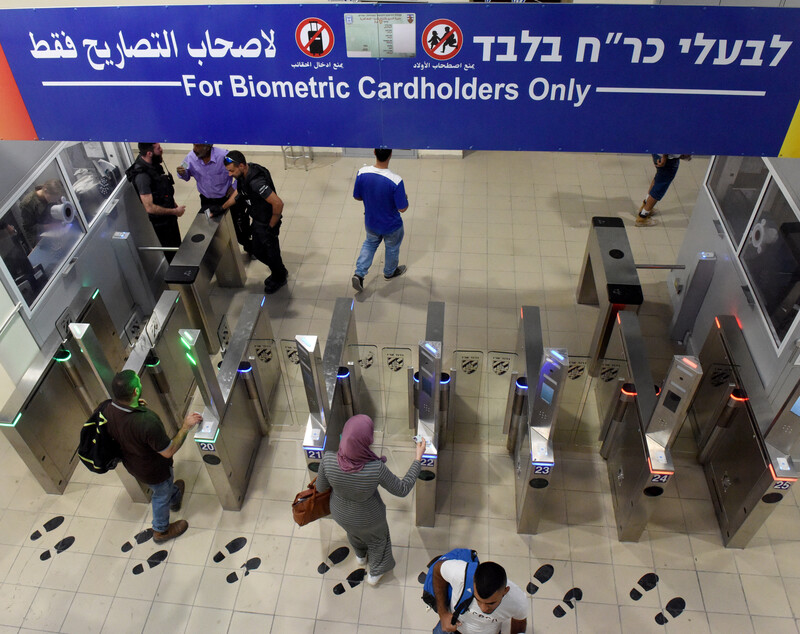 People pass through electronic gates