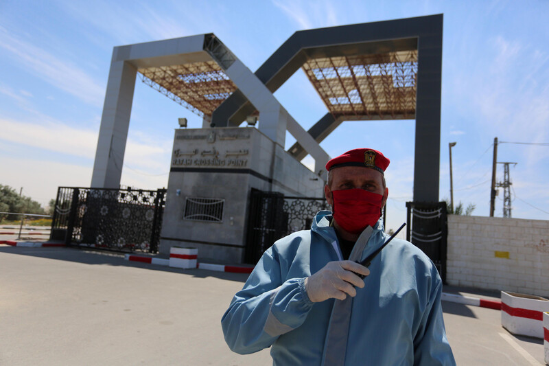 Security guard wearing protective gear standing before crossing