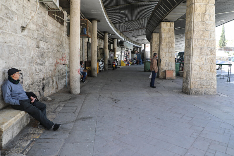 Man sits on a bench in empty market
