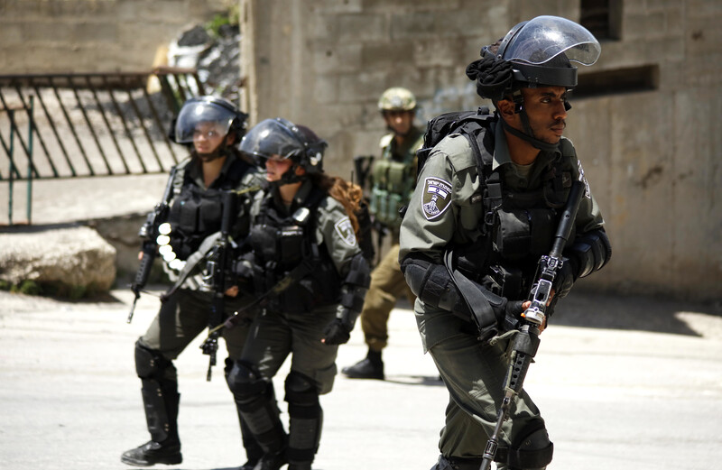 Heavily armed soldiers carrying rifles