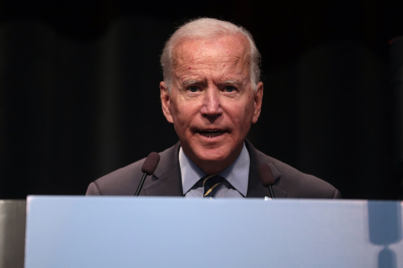 Man at podium looks straight ahead