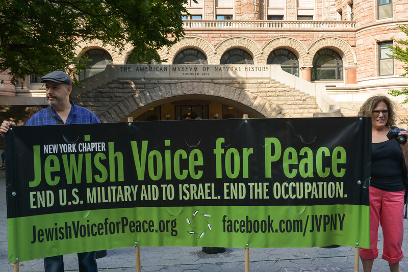 Protestors hold up a banner urging the US to end military aid to Israel