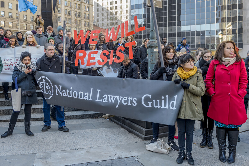 Protesters hold a banner.