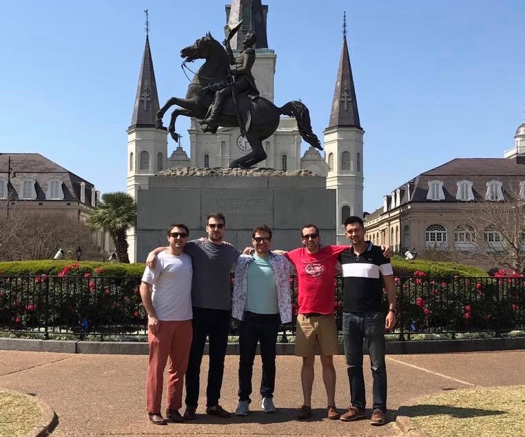 Five men stand in front of statue of Andrew Jackson on horseback