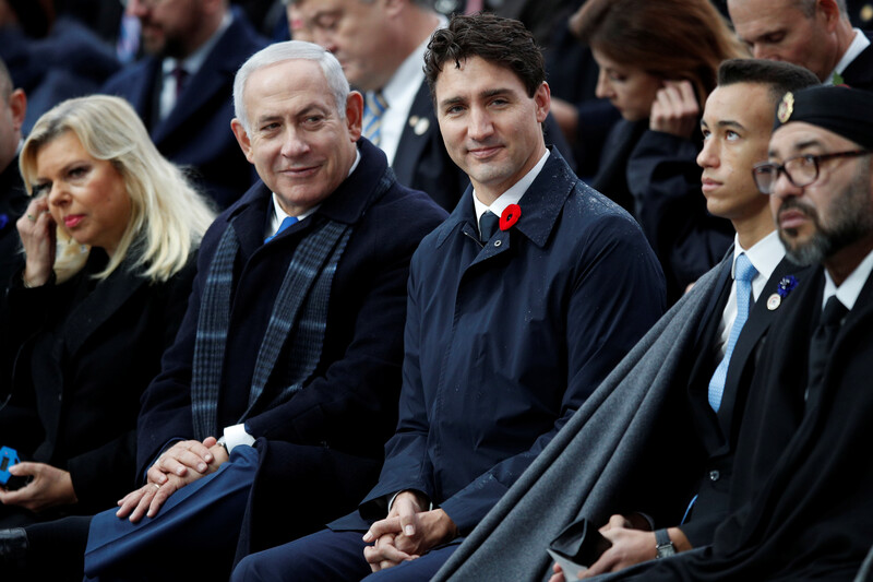 People dressed in suits sit together.