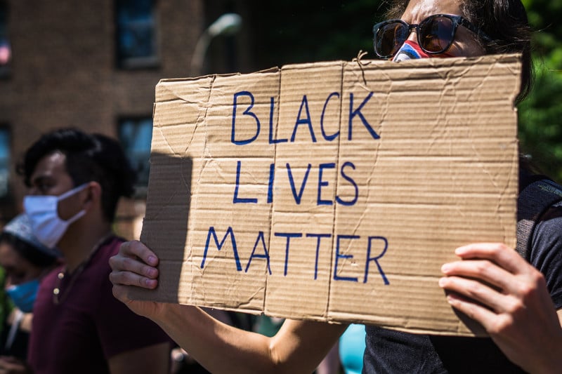 Protester holds sign reading Black Lives matter