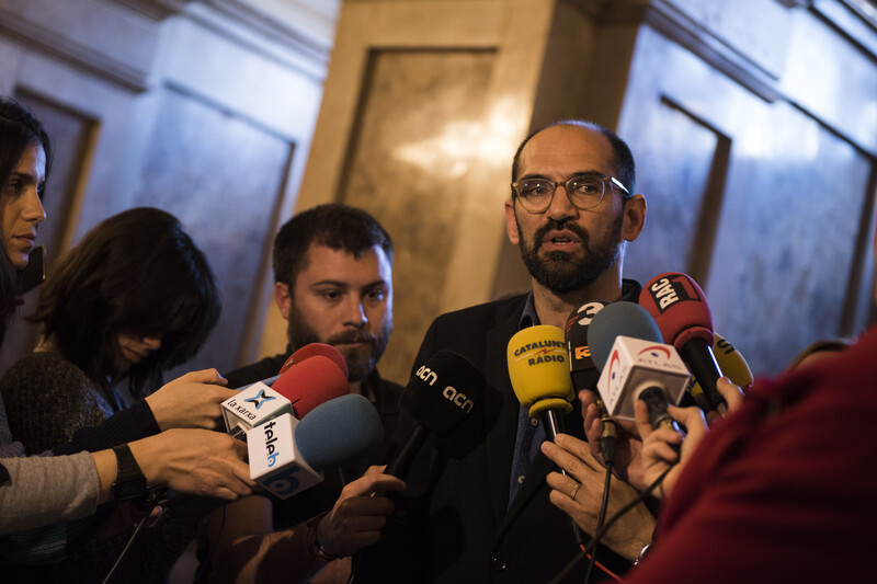 Man surrounded by microphones 