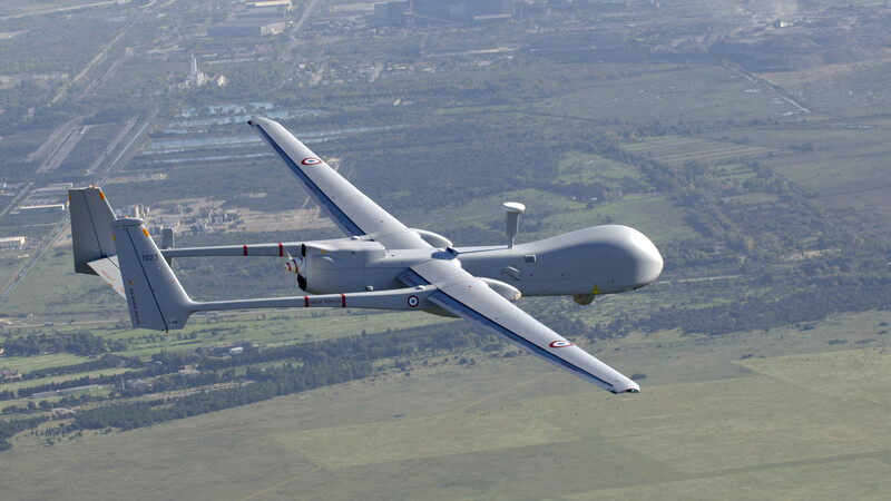 Drone suspended over land