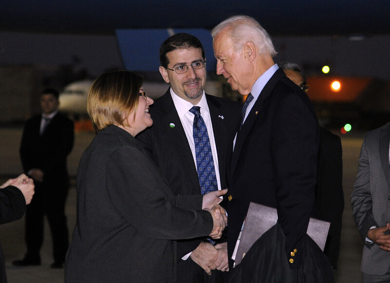 Three people talking at airport