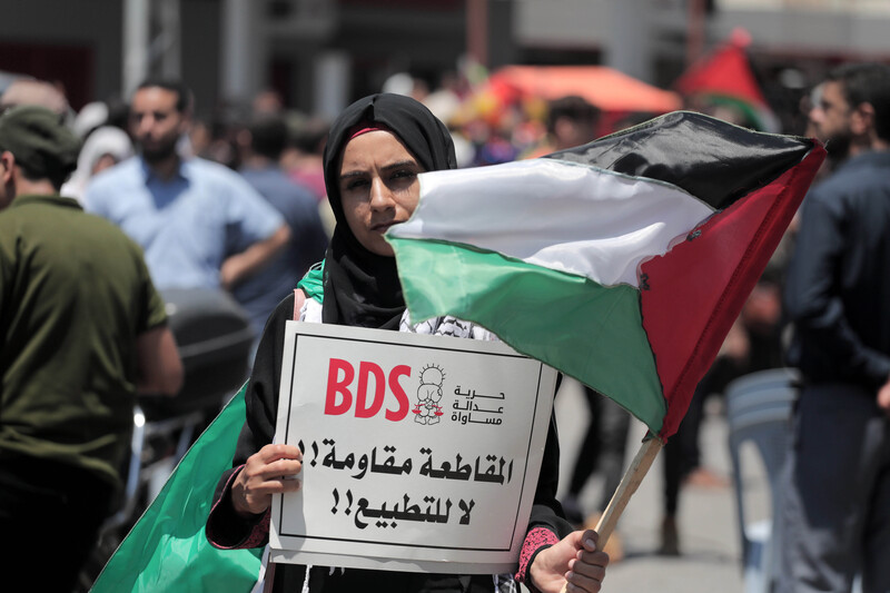 A woman holds a sign