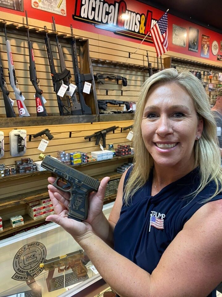 Woman poses with guns