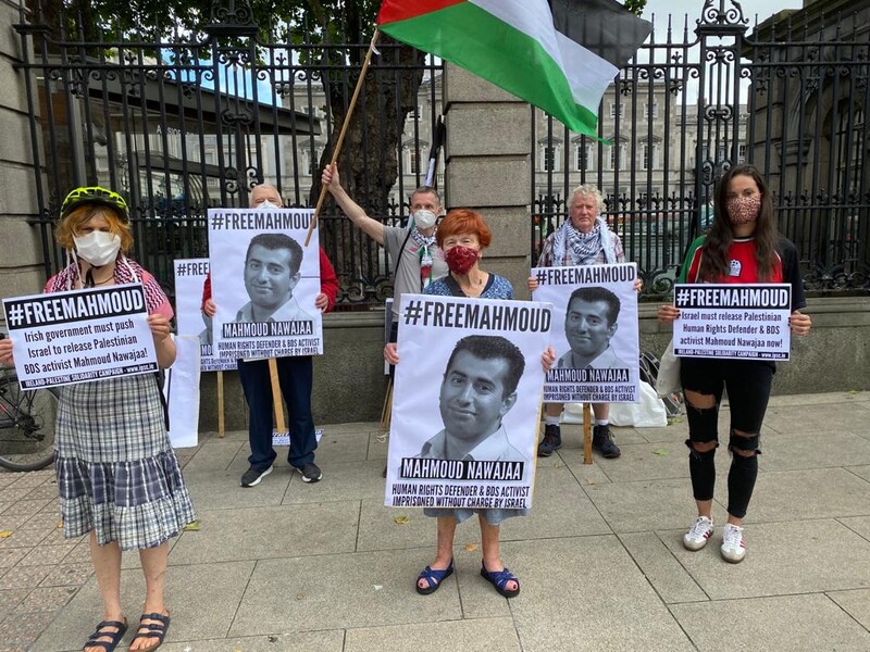 People hold signs and flags