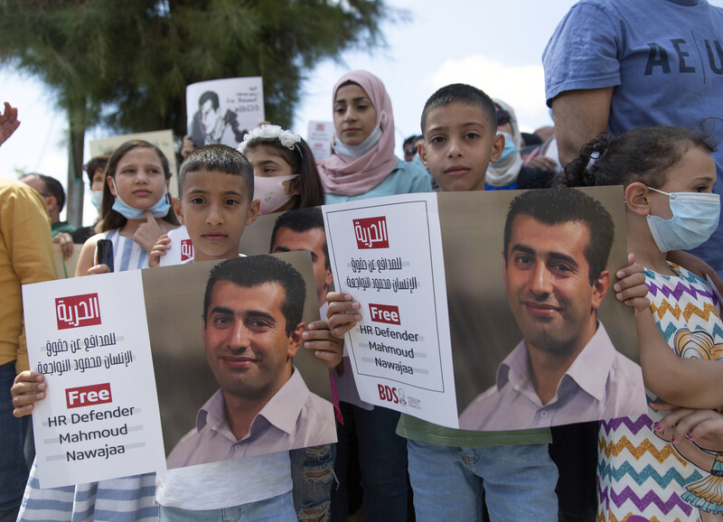 Children and adults hold signs