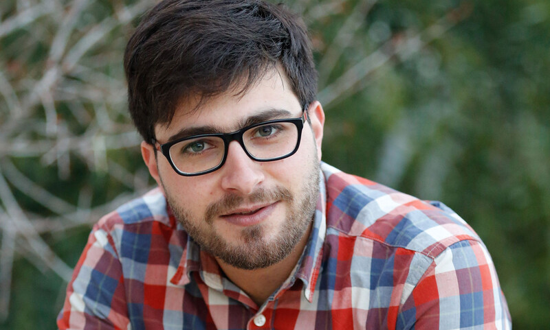 Headshot of smiling man wearing glasses