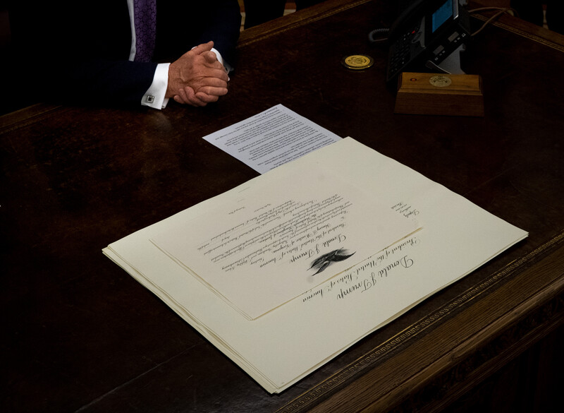 A document lies on a wooden desk