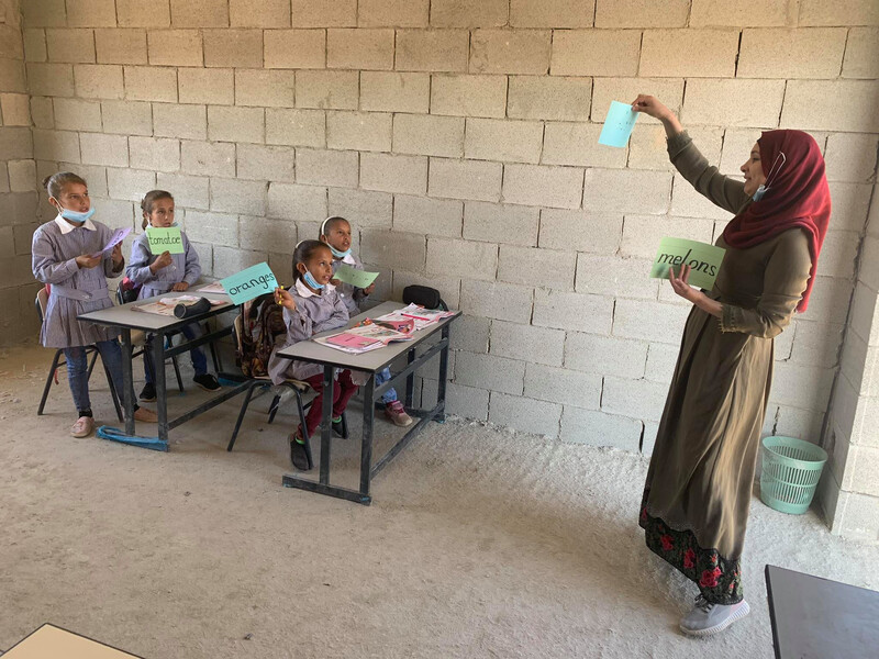 Teacher gives lesson to young students