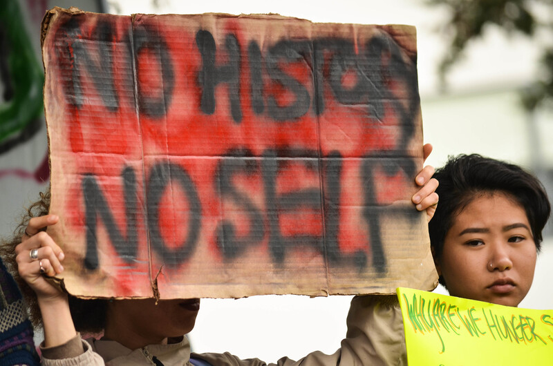 A protester holds a sign