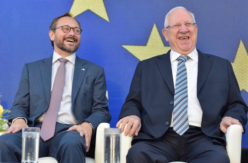 Two men sit in adjacent chairs