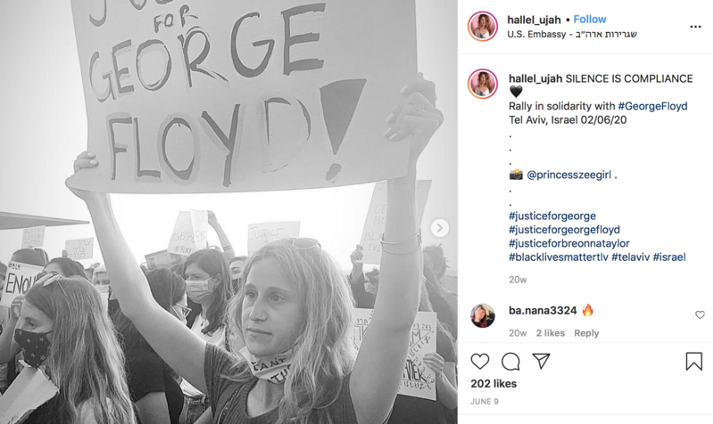 Woman holds justice for George Floyd sign