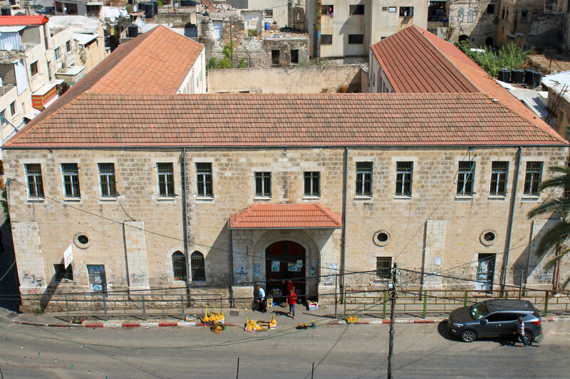 An old brick building with a red-tiled roof