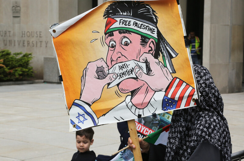 A woman holds a sign