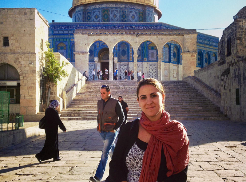 Woman stands outside the Dome of the Rock