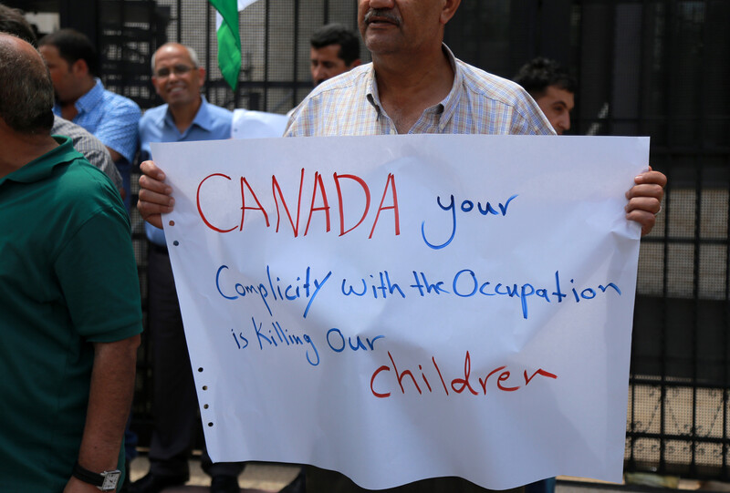 A man holds a sign