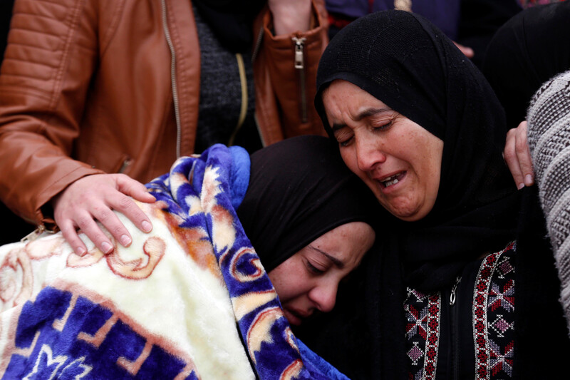 Two women embrace in tears 