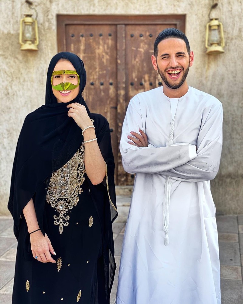 A man and woman dressed in traditional Emirati clothing