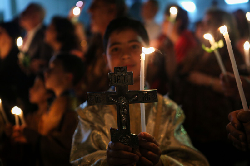 A boy holds a candle