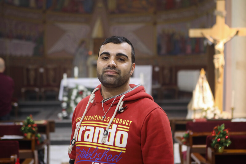 A man looks at the camera in an empty church