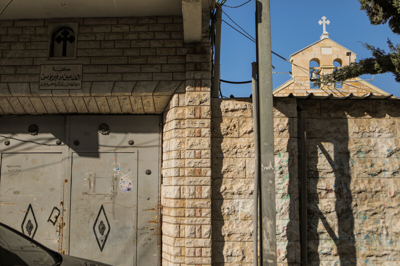 Church bells can be seen behind a shuttered metal door