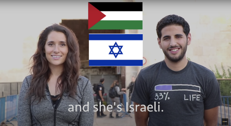 Two people stand side by side with Palestinian and Israeli flags between them