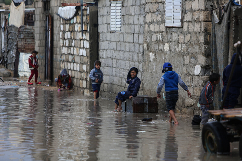 Children play on a flooded road