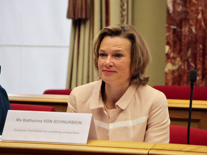 Smiling woman sits at table