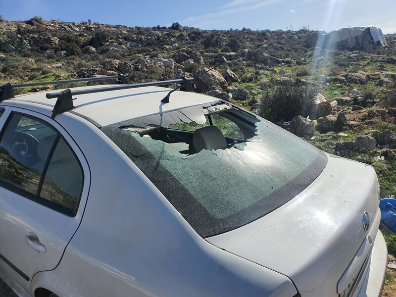 Sun shines on the broken back window of a car